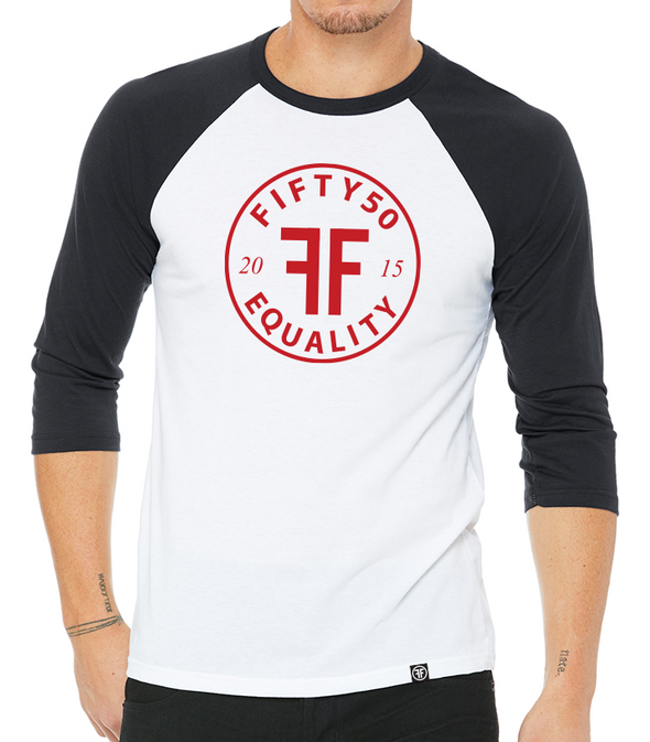 a male model wearing the capital raglan by fifty50 apparel which is a white and black raglan with a red logo