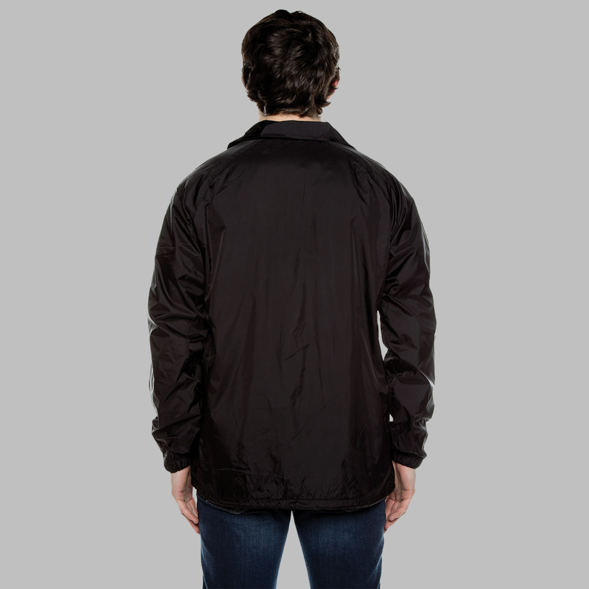 The back of a man wearing a black nylon jacket with a collar.  It is intended to show the fit and there is no logo or graphic.