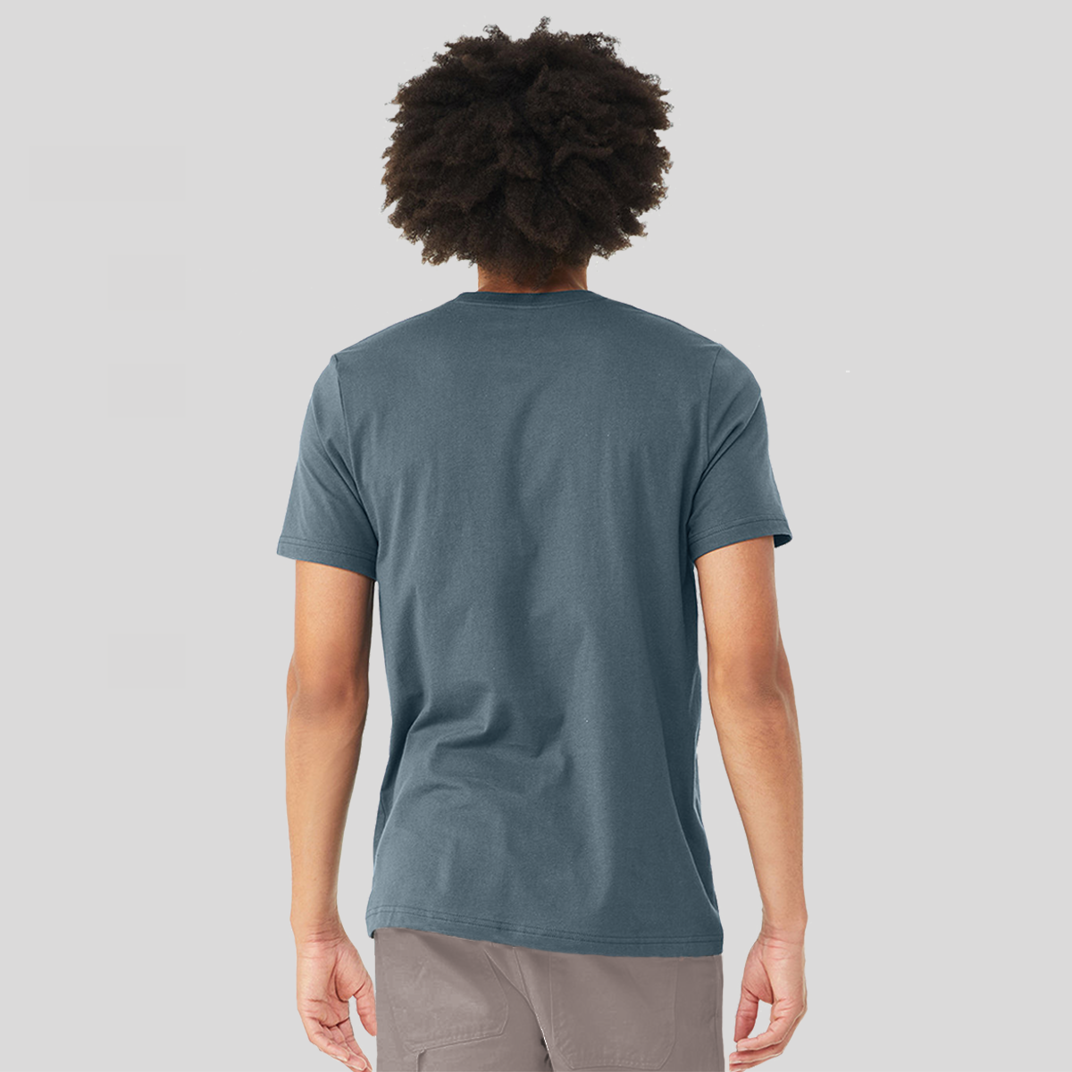 The back of a man wearing a Slate Blue t-shirt to show the slim fit and that there is no logo or graphic.