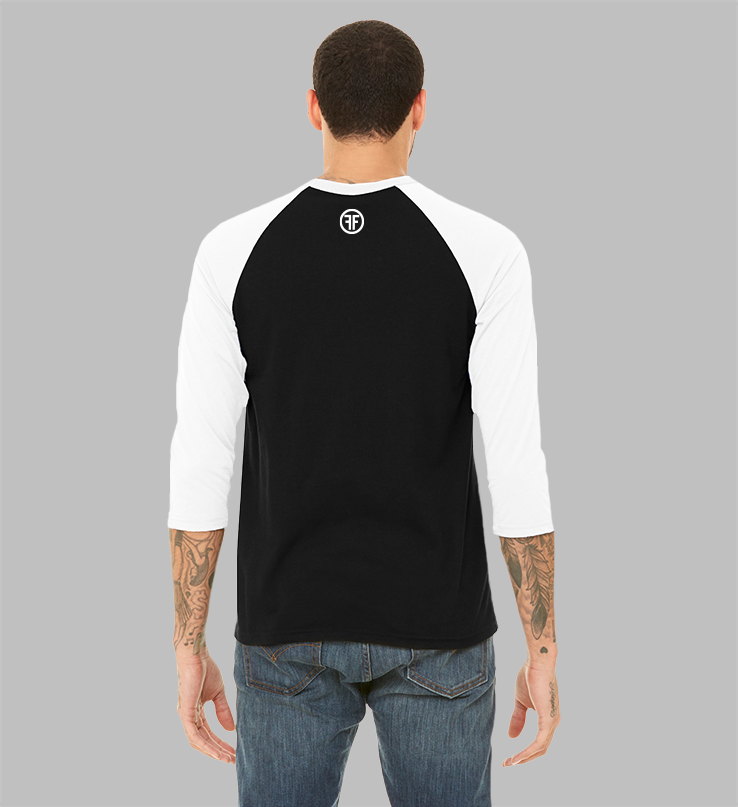 The back of a man in a black baseball t-shirt, with white arms and collar, to show the fit. There is a white logo below the collar, with two Fs back to back in a white circle.