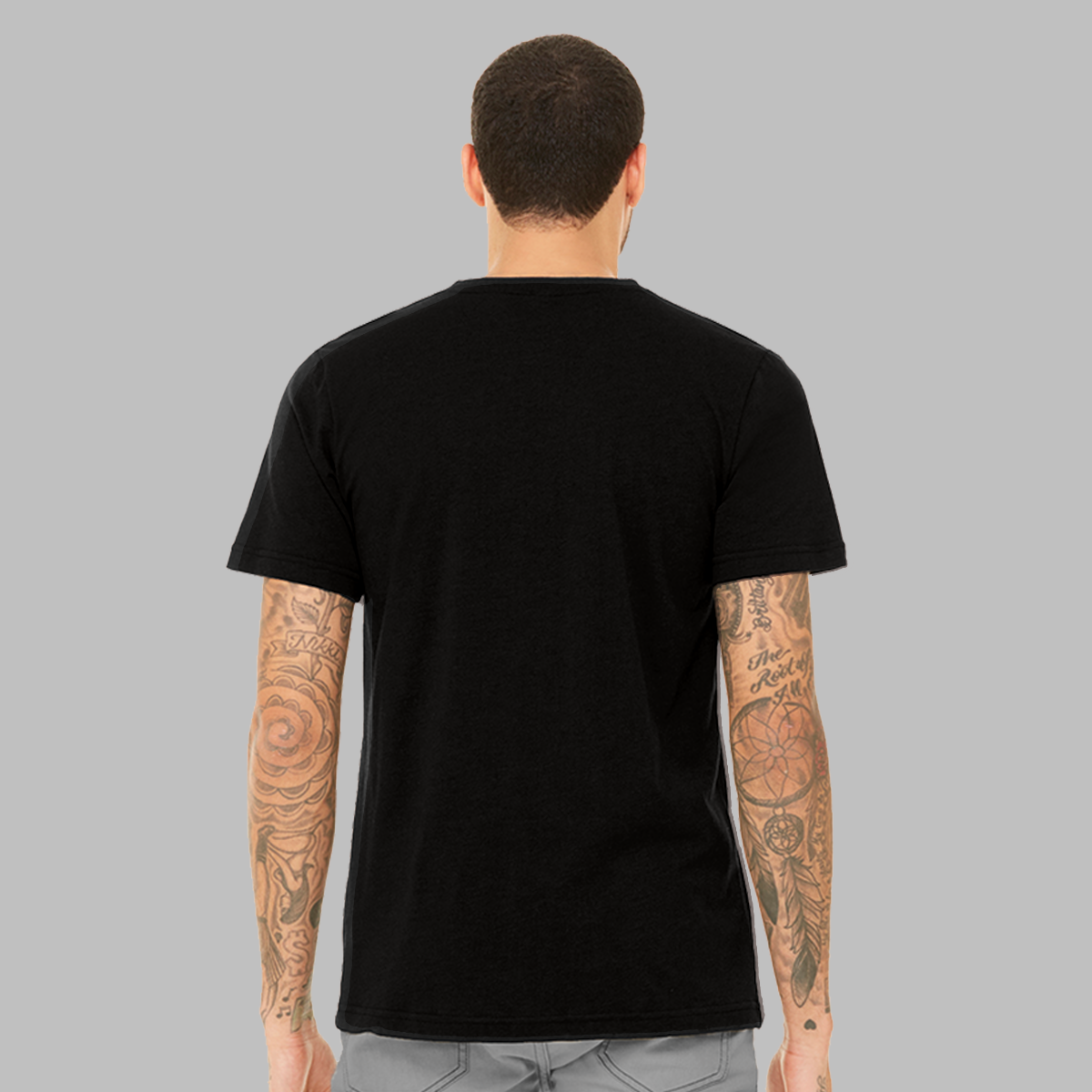 The back of a man wearing a black t-shirt to show the slim fit and that there is no graphic.