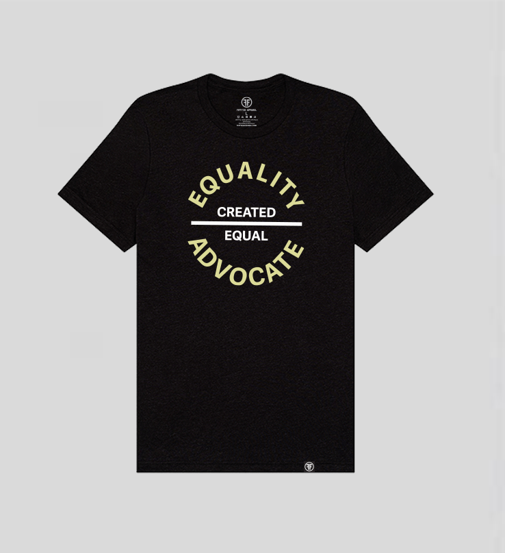 A black equality tshirt with a large circular center chest logo. The text Equality Advocate is in Bisque Gold, bold font, and the text Created Equal is in white bold font.