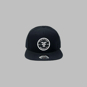 A black flat bill equality hat. The round black patch text reads, Fifty50, Equality, in bold white font, with two Fs, back to back, in the center.