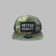 A camouflage, flat bill, snapback equality hat. It has a sewn on black patch that has the embroidered text Fifty50, Equality, in bold, grey font.