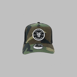 A camouflage trucker equality hat with black mesh side panels. The round black patch text reads, Fifty50, Equality, in bold white font, with two Fs, back to back, in the center.
