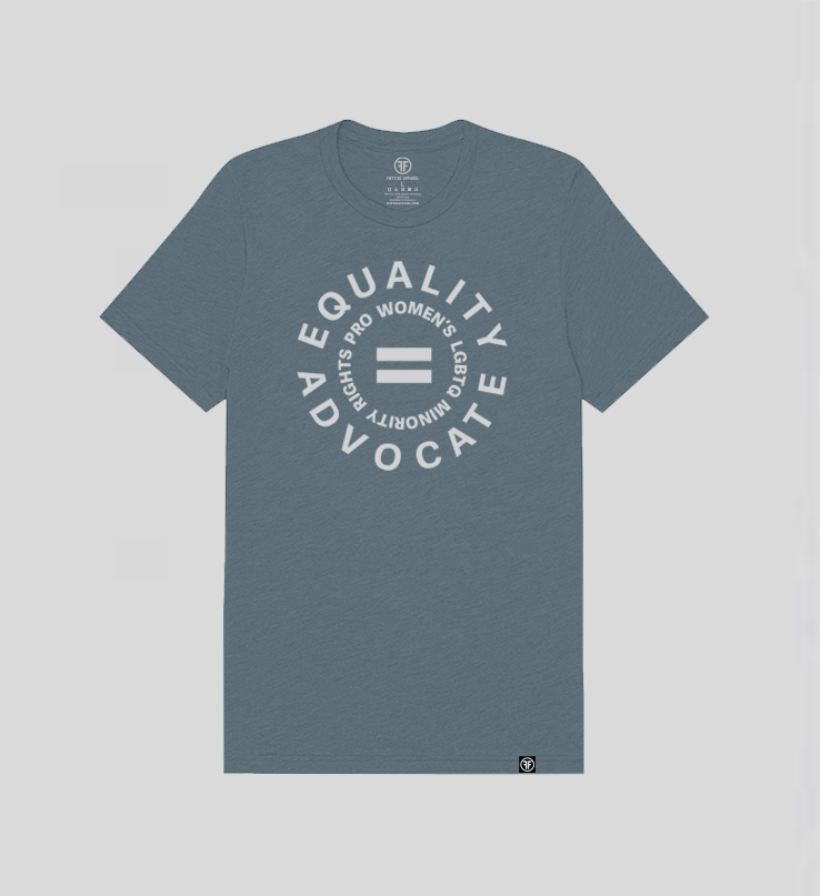 A Slate Blue human rights tshirt with a light grey logo. An equal sign is in the middle with the text Equality Advocate, and pro women's, lgbtq, and minority rights in circle around it. 