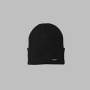 A black beanie has a 3.5" cuff, and a sewn on, black label tag. The tag has the text Fifty in white, and the number 50 in orange, with the text Apparel, in white, underneath it.