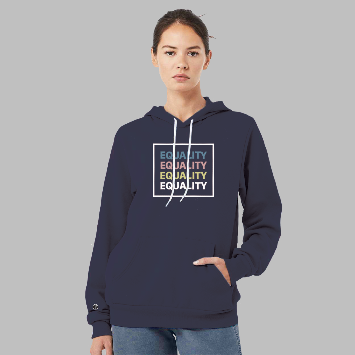 A lady wearing a navy blue equal rights hoodie with the text Equality, stacked four times, in Slate Blue, Dusty Rose, Bisque Gold, and white. The text is in bold font and is outlined by a white square.  