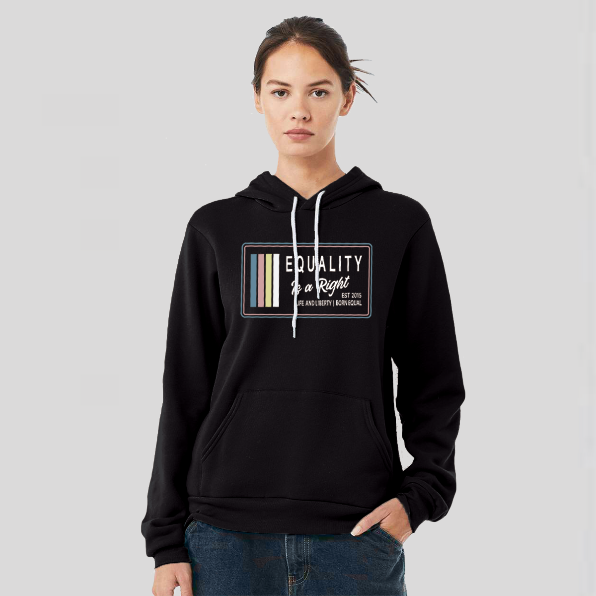 Lady wearing a black hoodie with the text, Equality, Life and Liberty, and Born Equal, in white bold font. The text, Is a Right, is in white script font. On the side of the logo are stripes of the colors Slate Blue, Dusty Rose, Bisque Gold, and white.