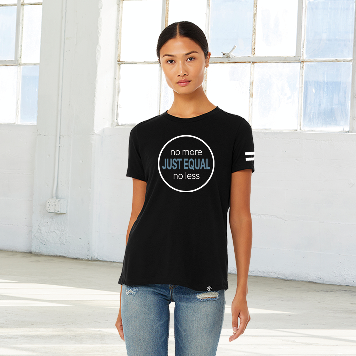 Lady wearing a black t-shirt with the words Just Equal in Slate Blue, bold font. In white text above, No More, and below, No Less. All outlined by a white circle. An equal sign is on the left sleeve. 