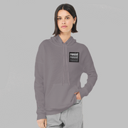 A lady wearing a slate purple, unisex political hoodie. The logo is a left chest black square, with text that says Resist, three times in white, light grey and dark grey. 