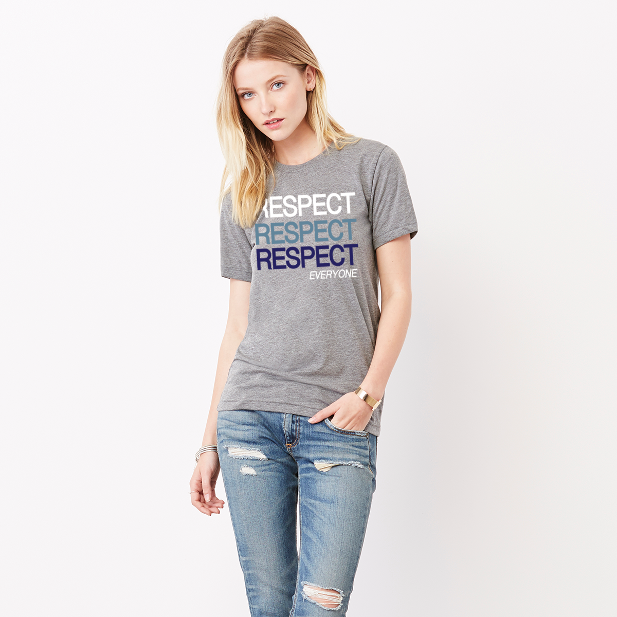 A lady wearing a grey unisex political t-shirt with text Respect Everyone. Respect is written in bold font in white, Slate Blue, and navy blue. 