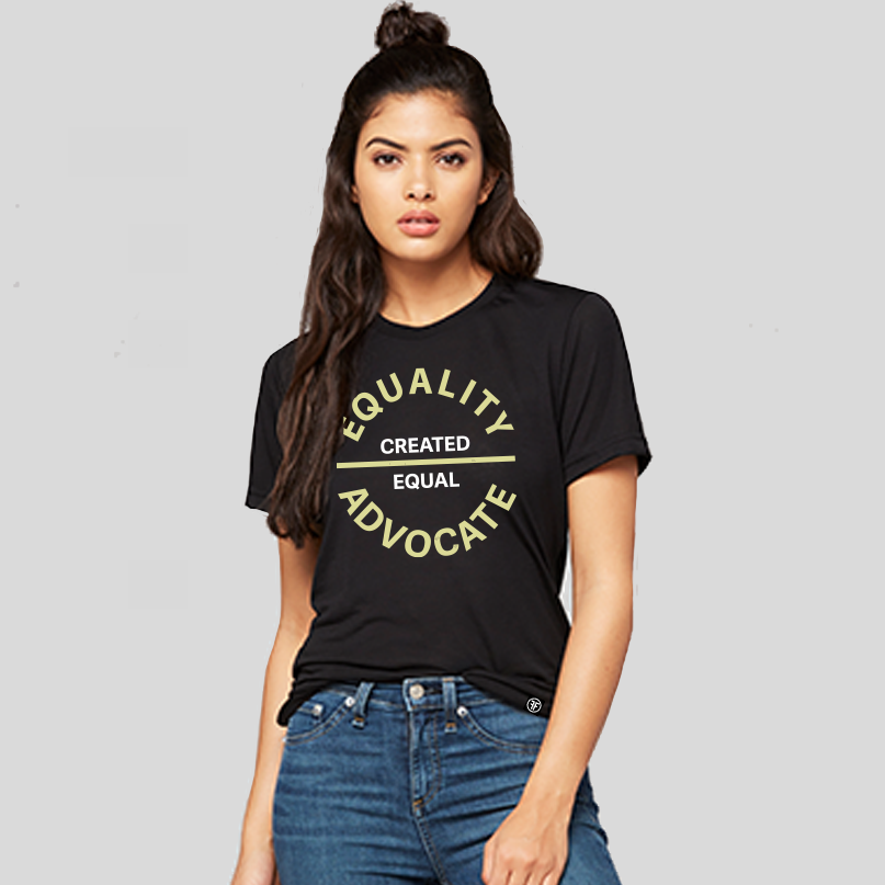 Lady wearing a black equal rights t shirt with a large center chest logo. The text Equality Advocate is in Bisque Gold, bold font, while the text Created Equal, is in bold white.