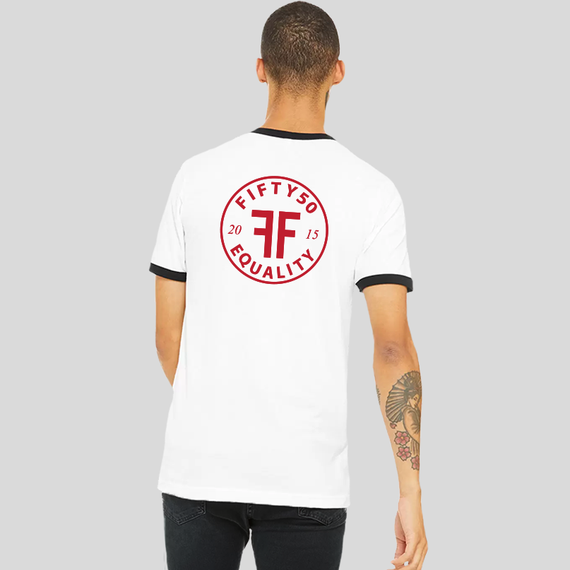 Back of a man wearing a white ringer t-shirt with black trim. Large, center back red logo is round and has the text Fifty 50 at the top and Equality at the bottom with two Fs, back to back in the middle.