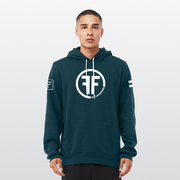 A man wearing a teal equality hoodie with a white equal sign on left arm, and the text, Fifty 50 Apparel is made for equality, no more, no less, just equal, on the right arm. Center chest logo has two Fs, back to back outlined by a circle.