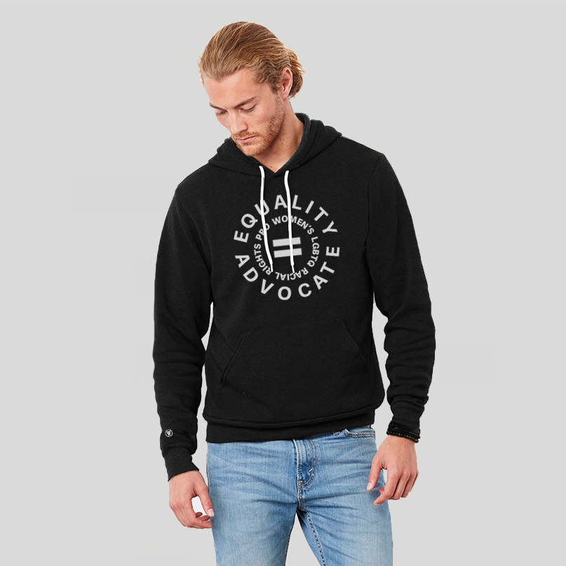 A man wearing an equal rights, black hoodie, with a light grey logo. An equal sign is in the middle with the text Equality Advocate, pro women's, LGBTQ, & racial rights around it.