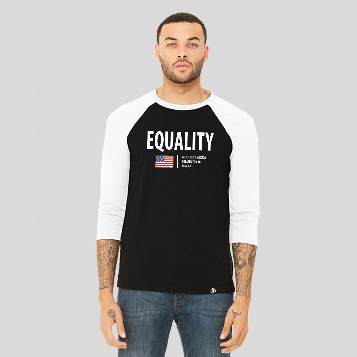 A man wearing a black baseball t-shirt with white arms and collar. The logo has the text, Equality, written in white bold font, and an American flag and the text, A fifty 50 America created for all.