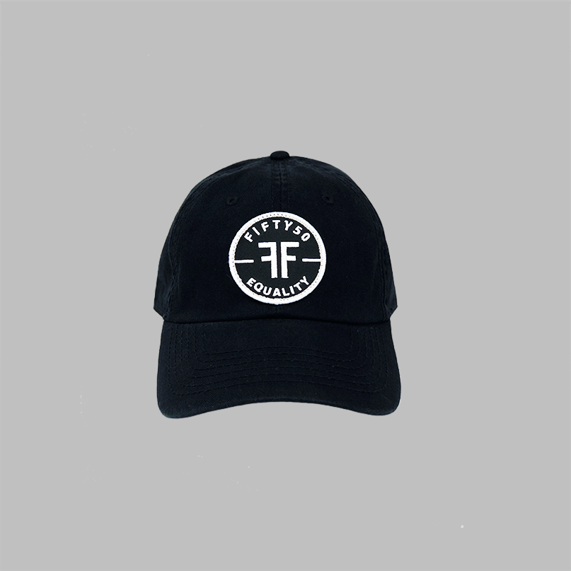 A black canvas Dad hat on a grey background. The round patch is black with the text Fifty50, Equality and two Fs, back to back in the center.