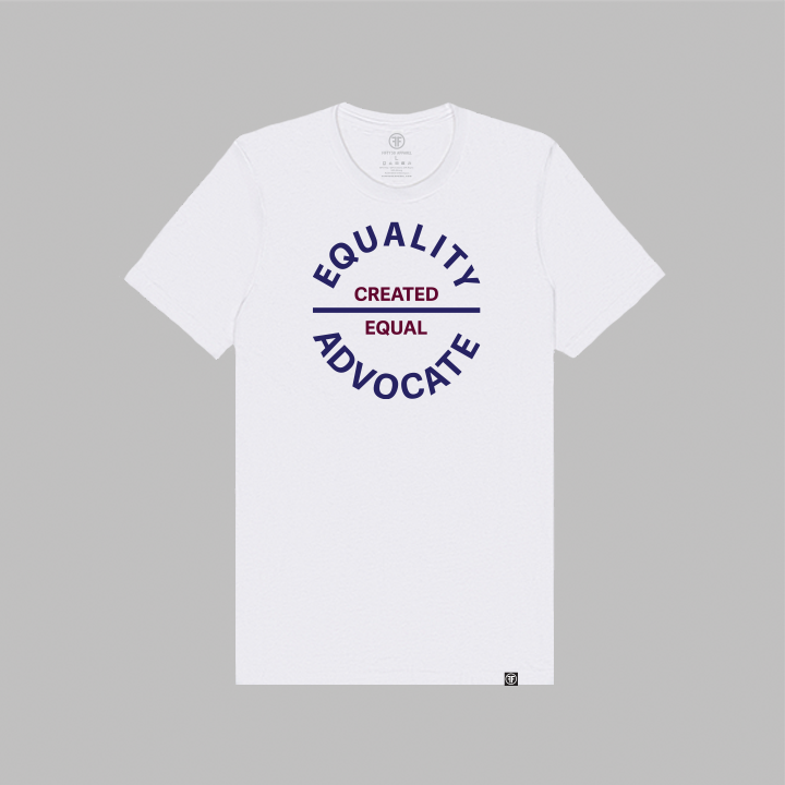 A white equality tshirt with a large circular center chest logo. The text Equality Advocate is in navy blue bold font, and the text Created Equal is in maroon bold font.