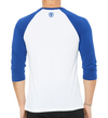 back of male model wearing the squared 50 raglan by fifty50 apparel which is a white and royal blue raglan with a royal blue logo near the neckline