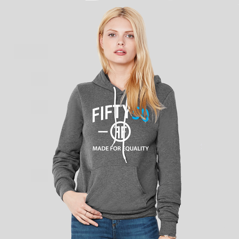 A lady wearing a charcoal grey hoodie with a logo. The text on the tee is in white and turquoise and reads Fifty50 and Made for Equality.