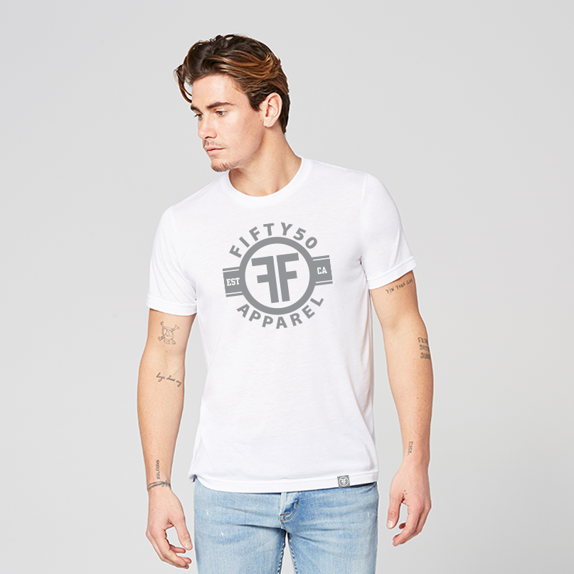 Man wearing a white equality tshirt with a grey graphic. The logo is in grey with the text, Fifty50 Apparel Est CA and two Fs, back to back, outlined by a circle. 