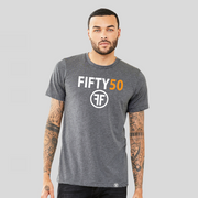 A man wearing a heather grey tshirt with a logo. The text Fifty is in white bold font and the number fifty is in orange bold font. Under the text are two white Fs, back to back, surrounded by a circle. 